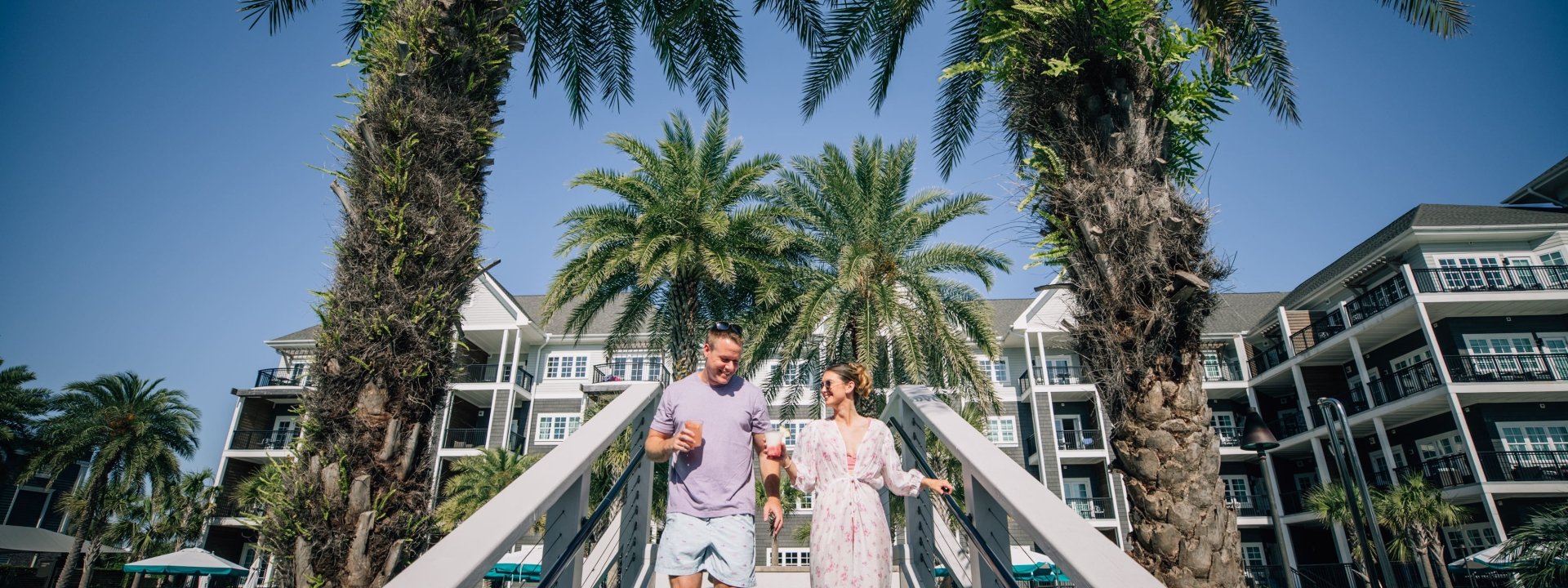Couple walking down stairs to beach