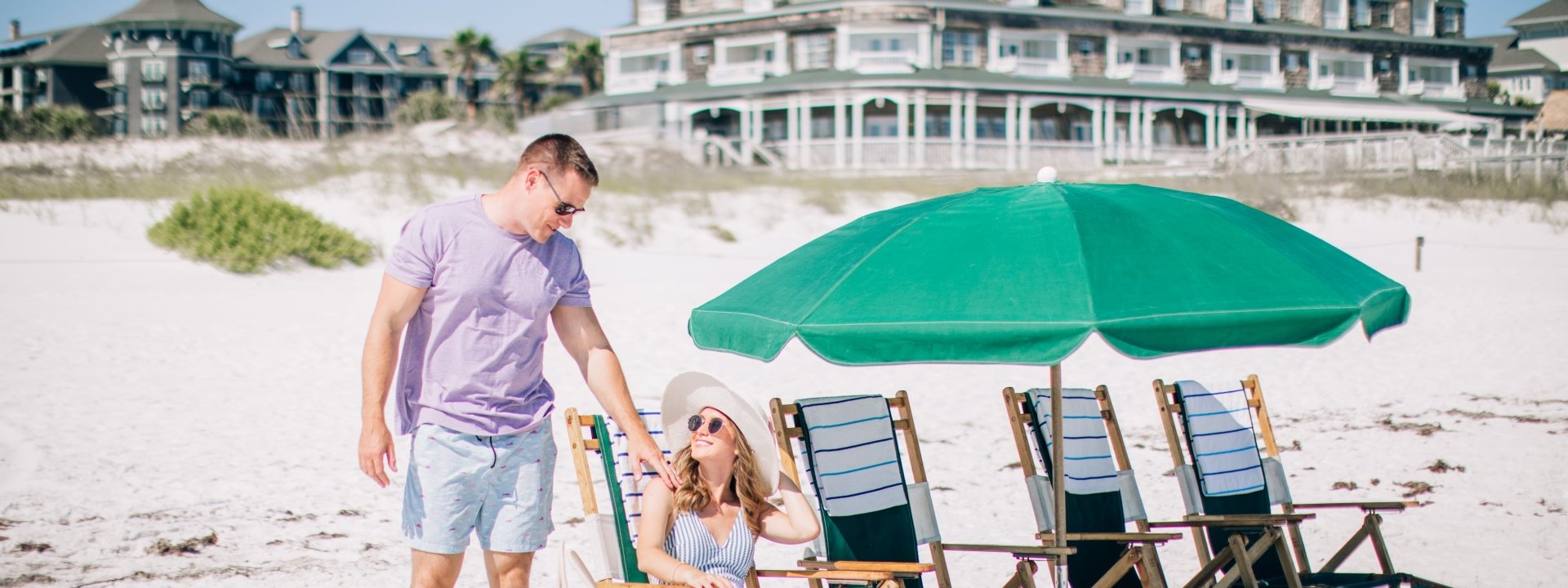 man & woman on beach chairs